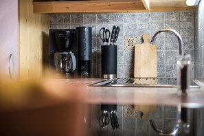 Fridge, stovetop, dishwasher, coffee/tea maker