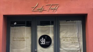 A storefront with a red facade and a black door. Above the door, there is a sign that reads "Lady Todd." - Lady Todd (Sliema)