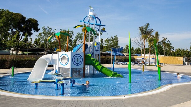 A water park with a central play structure, slides, and a pool. - Beachside Bungalow Escape (Cambrils)