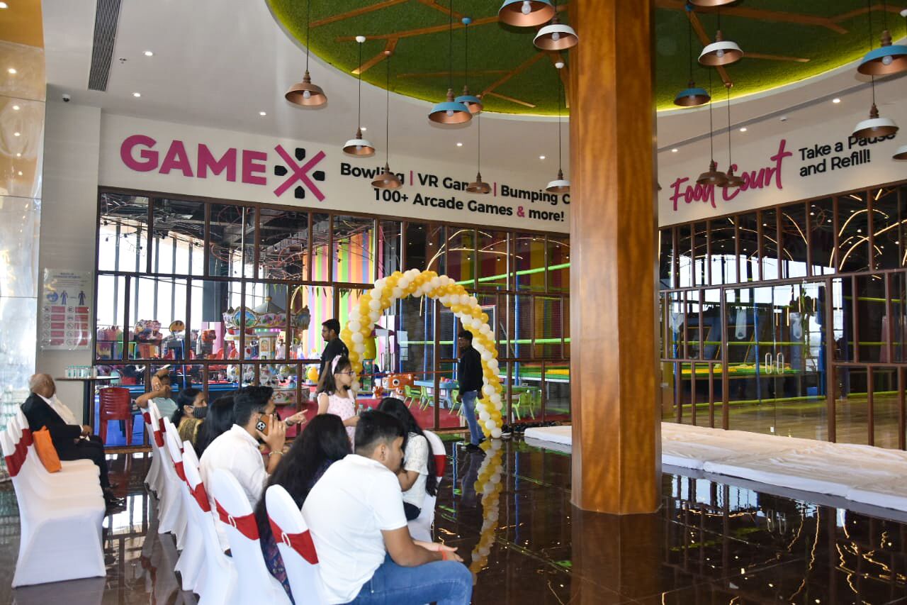 A gaming area with a sign for GAMEX and a food court.