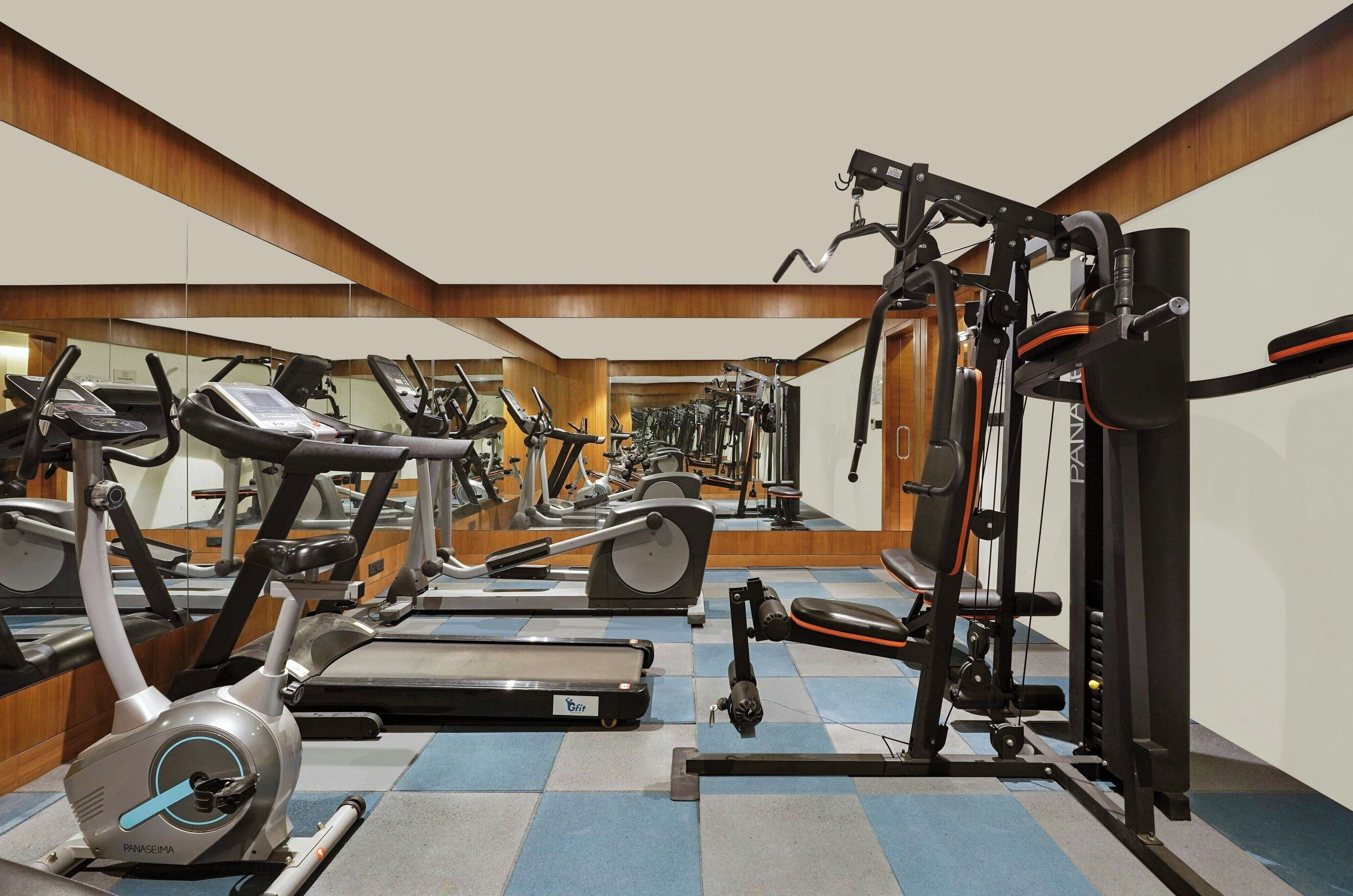 A gym with treadmills, elliptical machines, and weight machines.