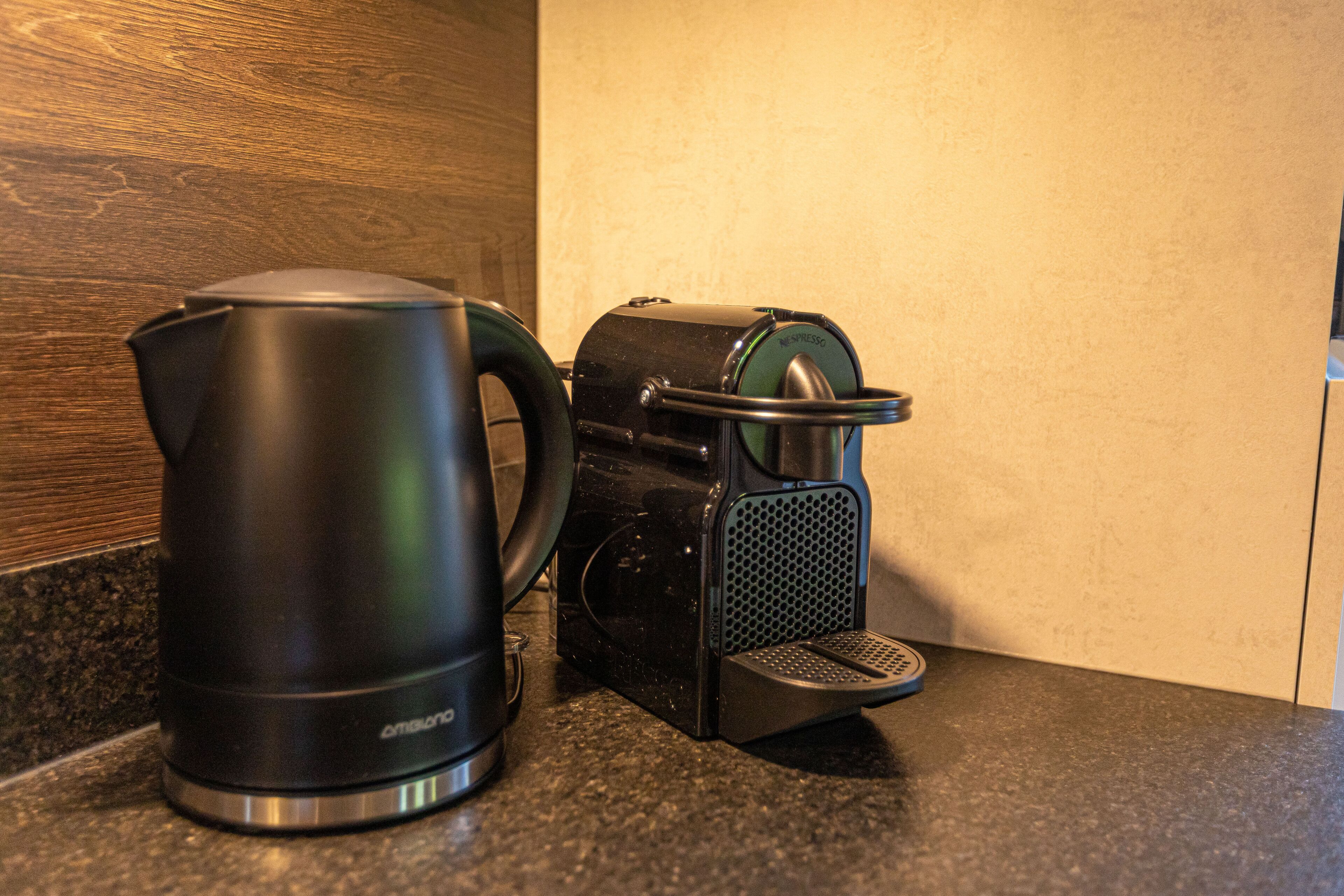 A coffee maker and a kettle on a kitchen counter.