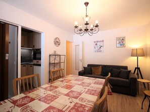 Cozy living space with a dining area, sofa, and kitchenette.
