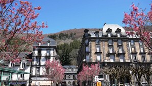 A street lined with buildings, including a hotel with a sign 'THERMES'.