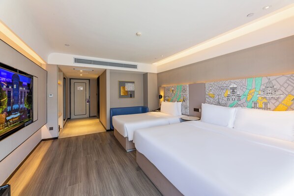 A hotel room with two beds, a television, a map on the wall, and a hallway leading to another room. - Mercure Harbin West Station (Harbin)