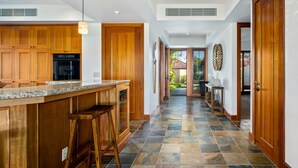 A kitchen with wooden cabinets, a granite countertop, and a built-in oven.