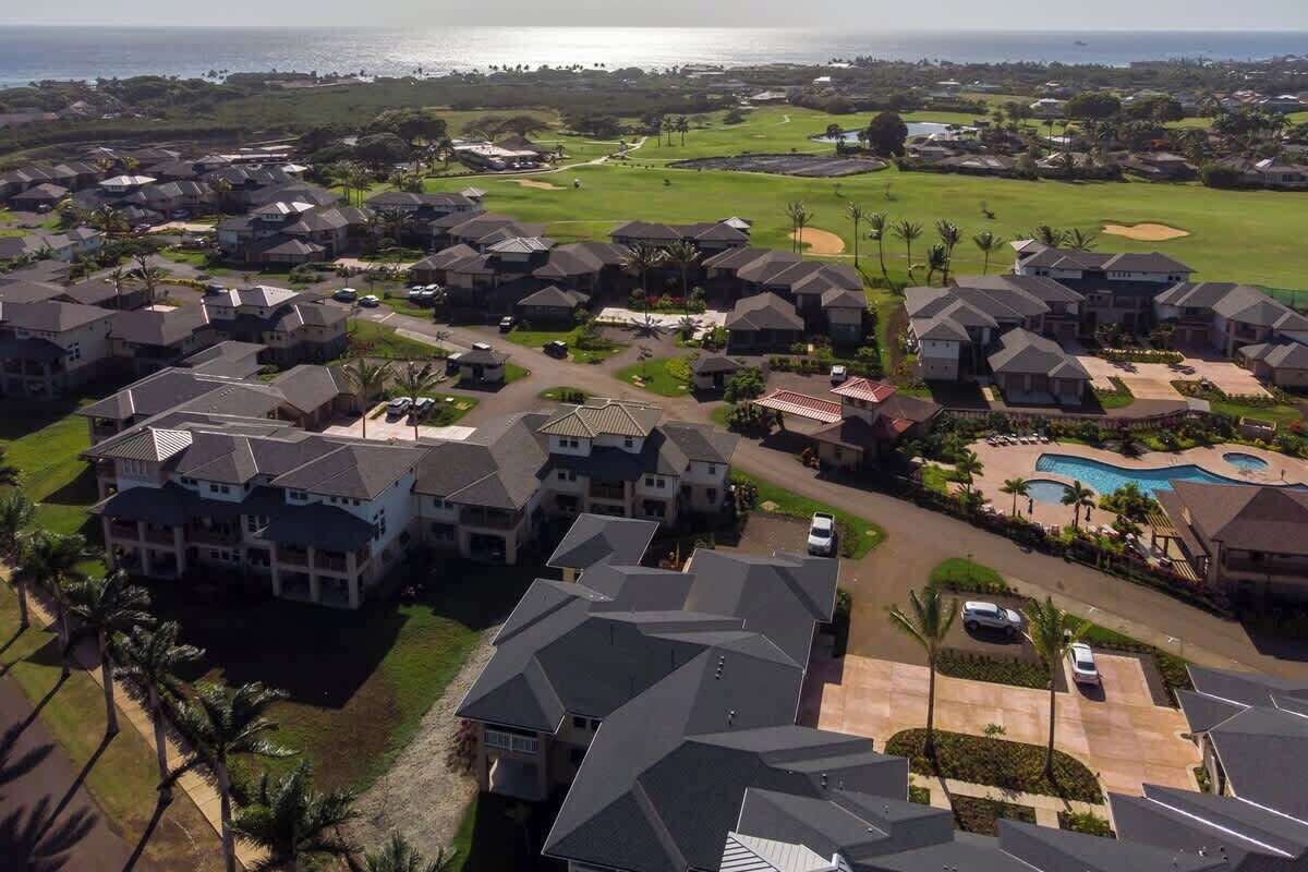 A residential area with houses, a golf course, and a swimming pool.