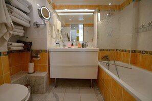 Bathtub, hair dryer, towels, soap