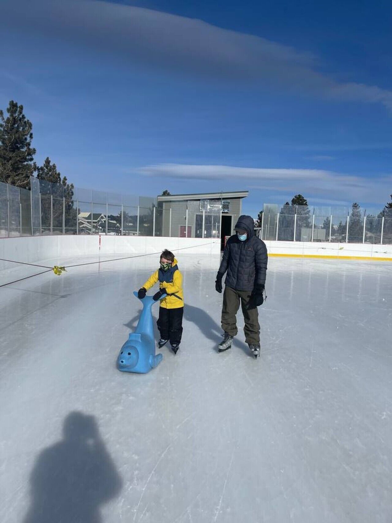 An indoor ice skating rink with a clear sky.