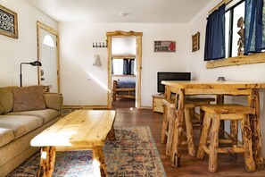 Relax in this inviting living space with a comfortable sofa, wooden coffee table, and matching bench.