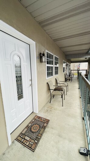 Relax on the covered porch with a comfortable seating area and a beautiful view.