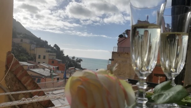 A balcony with a view of the sea, a rose, and two glasses of wine. - "Sea Drops" (CITR: 011024-CAV-0119) (Riomaggiore)