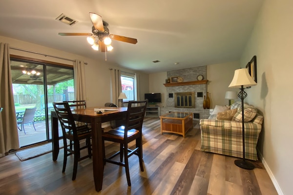 The kitchen opens to the living room. Dining table seats 6.