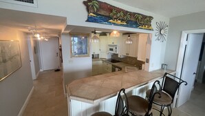 A modern kitchen with a central island, bar stools, and a decorative wall piece above the island. - 3/2 condo Futura Yacht Club Pool, Dockage, Wifi, dockage, beach (Islamorada)