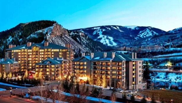 A multi-story hotel with a central courtyard, surrounded by snow-covered mountains. - The Westin Riverfront Resort & Spa, Avon, Vail Valley (Avon)
