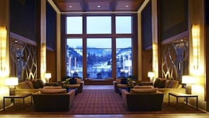 A spacious lobby with a large window offering a mountain view, furnished with sofas and lamps. - The Westin Riverfront Resort & Spa, Avon, Vail Valley (Avon)