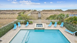 A pool area with a view of the beach and ocean. - Sun Sand & Sea, an Oceanfront 9BR House with Private Pool. (North Myrtle Beach)