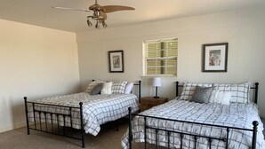 A bedroom with two twin beds, a ceiling fan, a window with blinds, and two framed pictures on the wall. - Paradise on the Bayou at the Bat Cave! (Slidell)
