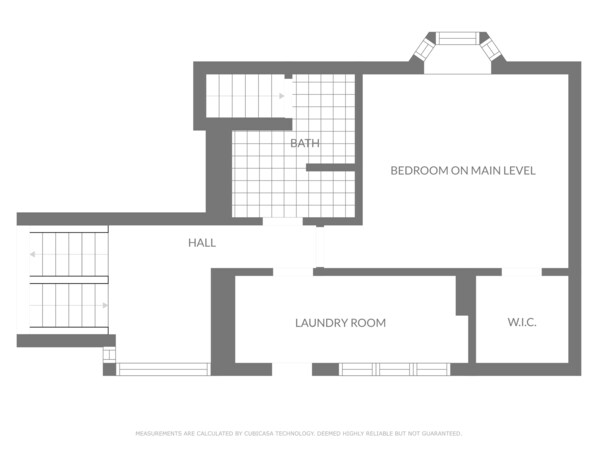 A floor plan with a bedroom on the main level, a bathroom, a hall, a laundry room, and a W.I.C.