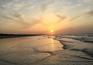 A beach at sunset with waves lapping onto the shore. - Fabulous Family 4BD Pool Rental (Mount Pleasant)