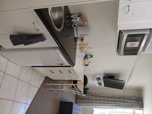 Enjoy cooking in this well-equipped kitchen with an oven, microwave, and island with a sink.