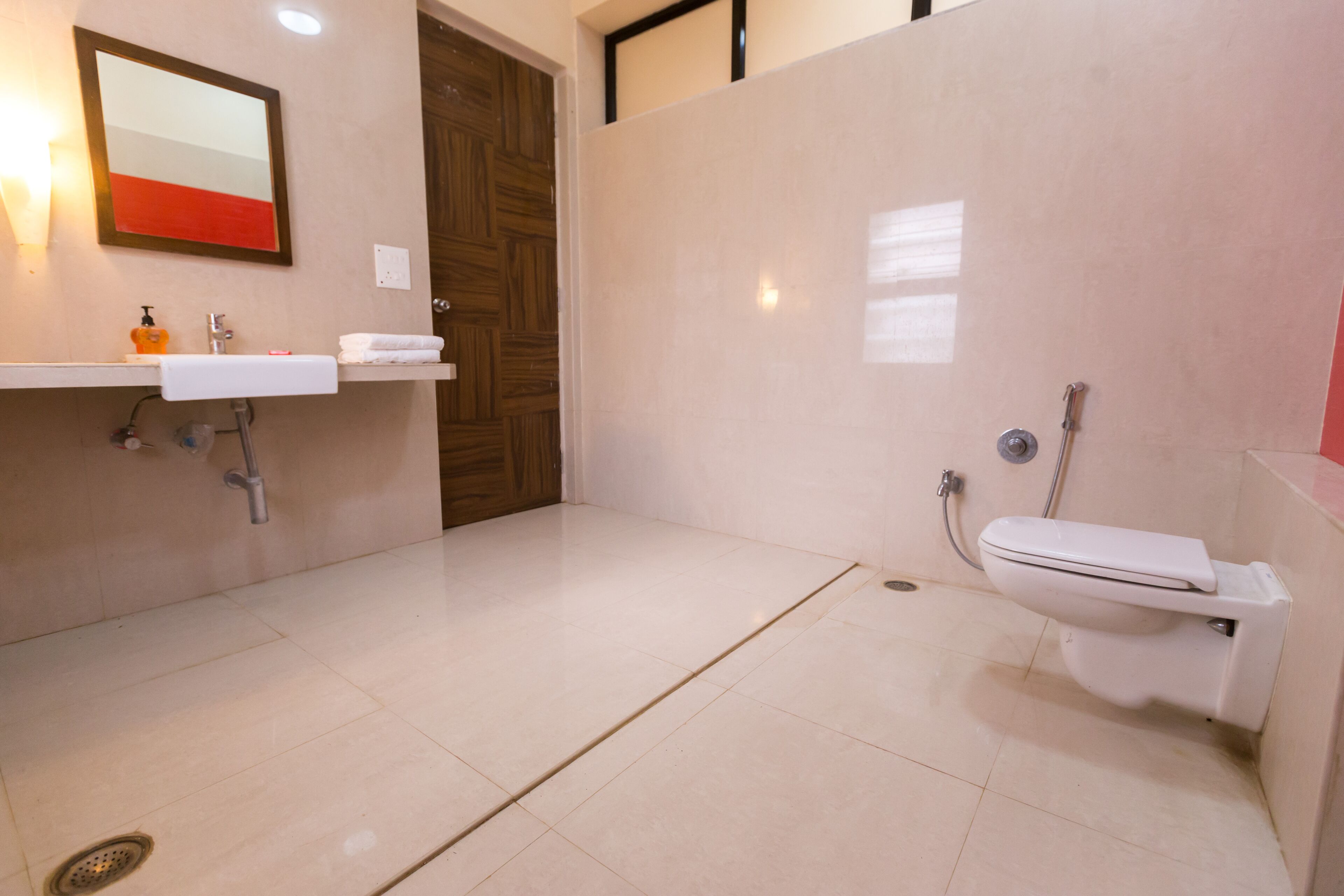 A bathroom with a sink, mirror, and toilet.
