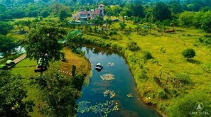 A riverside view with a house and lush greenery.