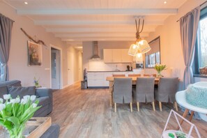 Enjoy a comfortable stay in this apartment with a spacious living area, dining table for four, and a well-equipped kitchen with a large island.