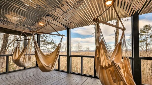 A room with a wooden floor, large windows, and two hammocks. - A Blue Ridge Mason Jar | Blue Ridge, GA (Blue Ridge)