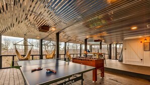 A spacious room with a ping pong table, foosball table, and large windows offering views of the outdoors. - A Blue Ridge Mason Jar | Blue Ridge, GA (Blue Ridge)