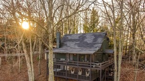 A multi-level wooden cabin with a balcony, surrounded by trees. - A Blue Ridge Mason Jar | Blue Ridge, GA (Blue Ridge)