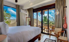 Relax in comfort with a large bed and outdoor space overlooking the beach.