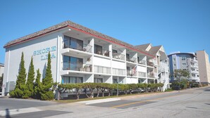 A multi-story hotel with balconies and a sign reading "SHORE LIA". - One-bedroom and one and a half bath condo on ocean block! (Ocean City)