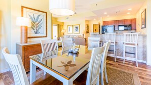 A modern kitchen with white cabinetry, a microwave, and a refrigerator. - Gulf Views ~ Private Balcony ~ Community Pool (Miramar Beach)