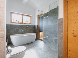 Bathtub, hair dryer, towels, soap