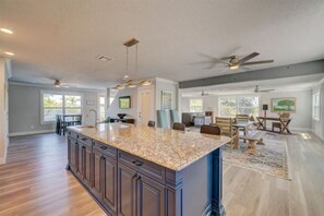Enjoy a spacious kitchen with a large island, modern cabinetry, and a dining area.