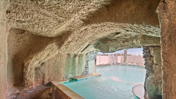 A natural rock pool with a stone wall and a small stone structure. - 2 Night Minimum Stay in Off Season - Pet Friendly 8BR Oceanfront Home in Cherry Grove, Game Room & Beautiful Pool (ISLELAG) (North Myrtle Beach)