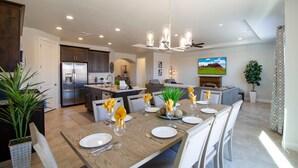 A modern kitchen with a dining area set for a meal. - Paseos 1146| Private Hot Tub, Pickleball Court, Access to Community Pool (Washington)