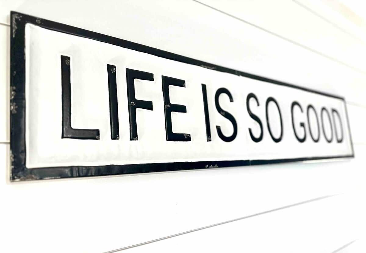 A sign with the text "LIFE IS SO GOOD".