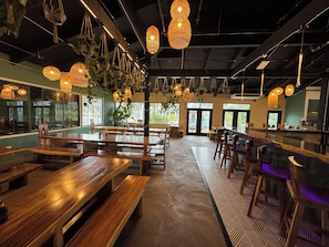 Relax in a warm and inviting space with comfortable seating options and large windows offering views of the outdoors.