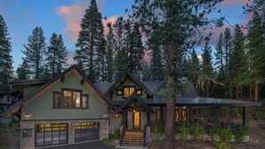 A two-story log cabin with a stone foundation, a large garage, and a covered porch. - NEW - Truckee Luxury Retreat - Remote Work Friendly - Sleeps 10+ (Truckee)