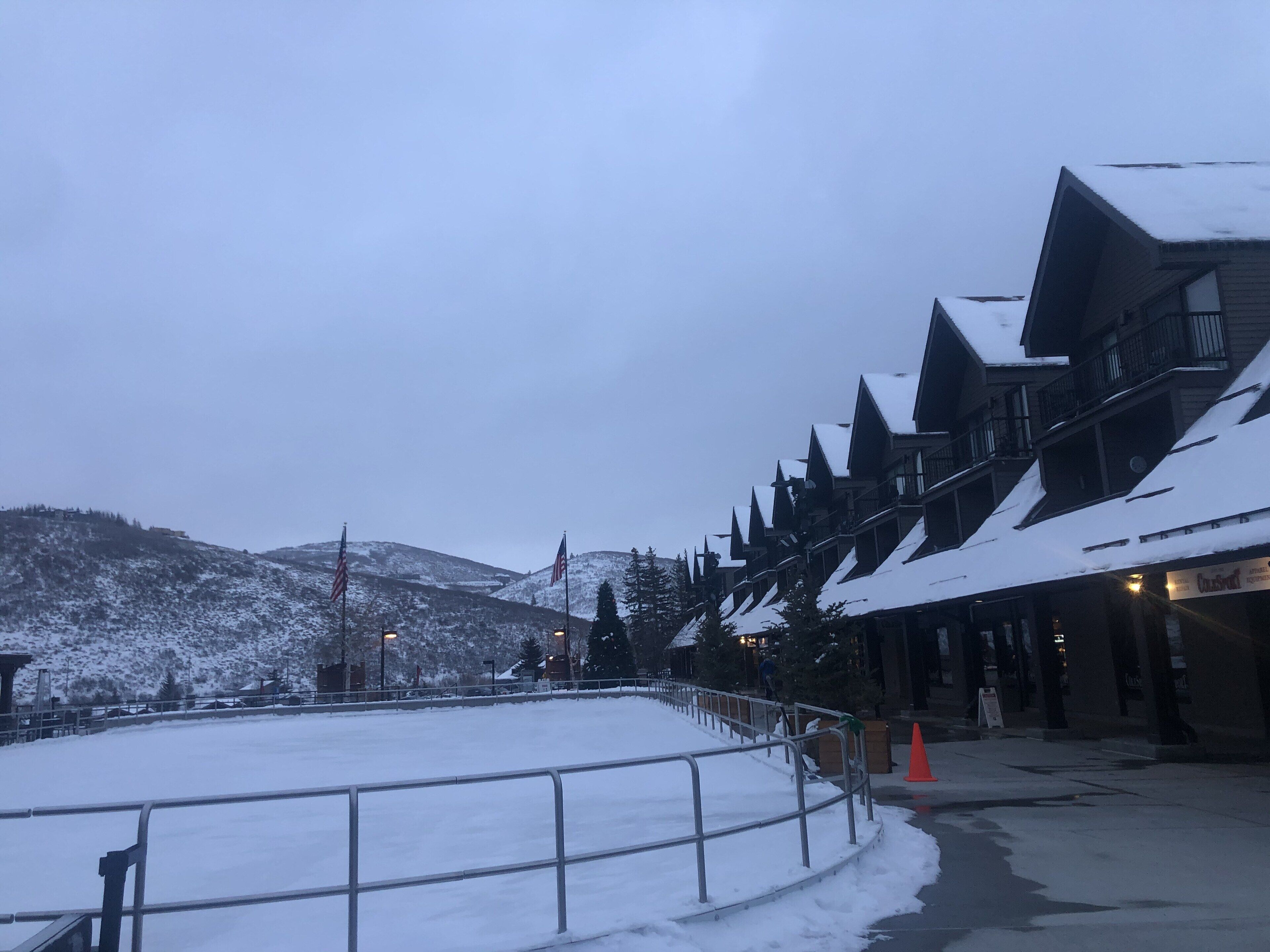 A snow-covered building with a ski slope in the foreground.