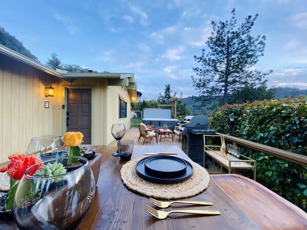 Enjoy al fresco dining on the deck, surrounded by a forest view and a barbecue grill.