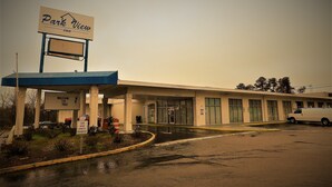 A Park View Inn with a gas station, a covered parking area, and a building with multiple windows.