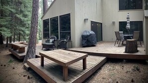 A modern cabin with a deck, outdoor seating, and large windows. - Good Vibes All Around: Aspen Sixteen at Black Butte Ranch (Black Butte Ranch)