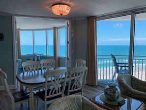 Enjoy ocean views from the comfort of your room, which features a dining table, sofa, and balcony with a chair.