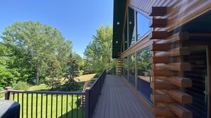 Enjoy a serene view from the balcony overlooking lush green surroundings.