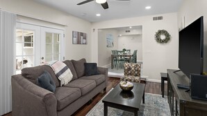 A modern living room with a sofa, coffee table, and TV stand. - Hidden Gem Upgraded 4/2 in NW Fresno w RV Parking (Fresno)