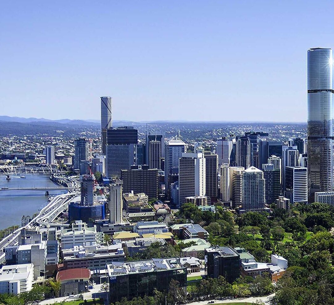 A cityscape with modern high-rise buildings, a river, and a bridge.