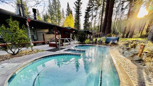 A swimming pool with a tiled edge, surrounded by a brick patio and a wooden deck. - SPECIAL DISCOUNT on Penthouse in NorthstarVillage,a wonderful getaway (Truckee)